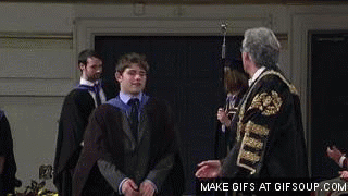 picture of sad guy receiving diploma